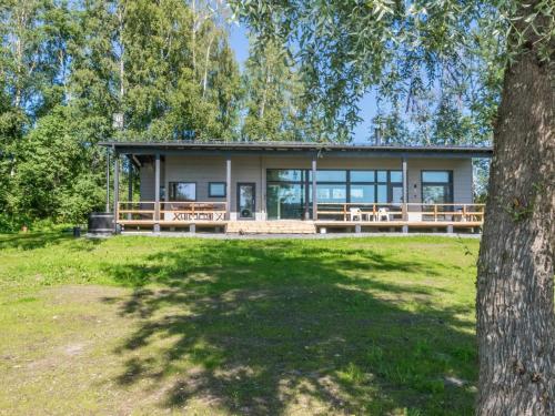 a large house with a tree in front of it at Holiday Home Villa aura by Interhome in Pälkäne