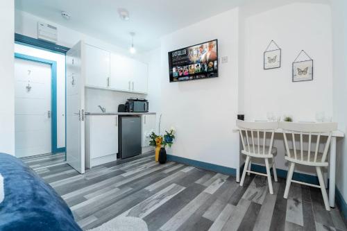 a living room with a kitchen and a table and chairs at Sky Rooms One Bedroom Modern Studio Apartment 8 in Birmingham