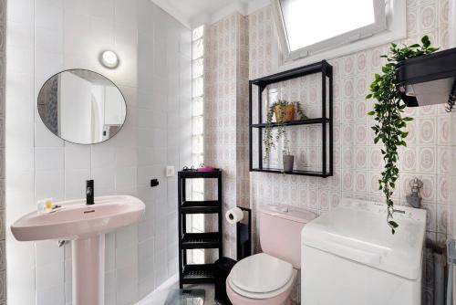 a bathroom with a sink and a toilet and a mirror at Apto El Dorado 929 in Playa de las Americas