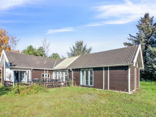 a house on a grassy field with a house at Holiday Home Fredrike - all inclusive - 500m from the sea by Interhome in Vester Sømarken