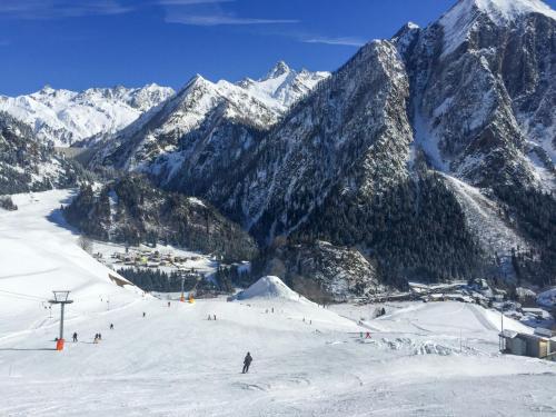 a group of people skiing down a snow covered mountain at Holiday Home Rustico Orsaira by Interhome in Campo Blenio