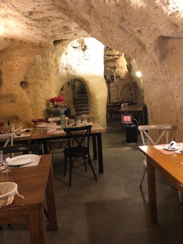- un restaurant avec des tables et des chaises dans une grotte dans l'établissement Chez Annie, à Doué-la-Fontaine