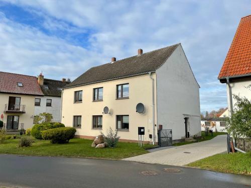 a white house on the side of a street at Apartment Haus Stefanie by Interhome in Trinwillershagen