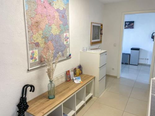 a room with a table with a map on the wall at Apartment Haus Stefanie by Interhome in Trinwillershagen