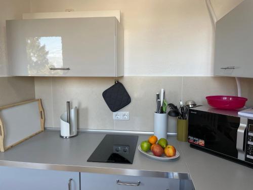 a kitchen with a bowl of fruit on a counter at Apartment Haus Stefanie by Interhome in Trinwillershagen