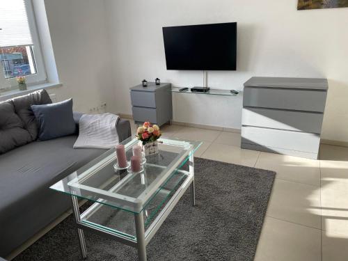 a living room with a couch and a glass coffee table at Apartment Haus Stefanie by Interhome in Trinwillershagen
