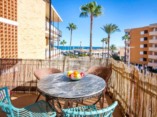 a bowl of fruit sitting on a table on a patio at Apartment Vista del Arenal by Interhome in Jávea