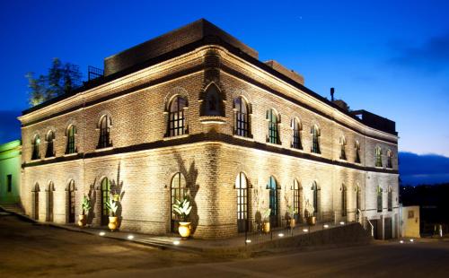 a large brick building with lights on it at Guaycura Boutique Hotel, Beach Club & Spa in Todos Santos