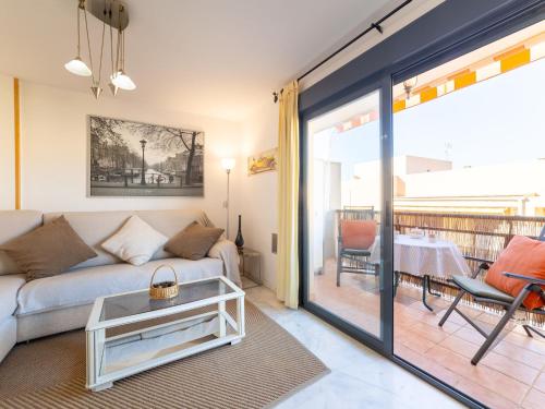 a living room with a couch and a table at Apartment Dioniso - Playa Romanilla by Interhome in Roquetas de Mar