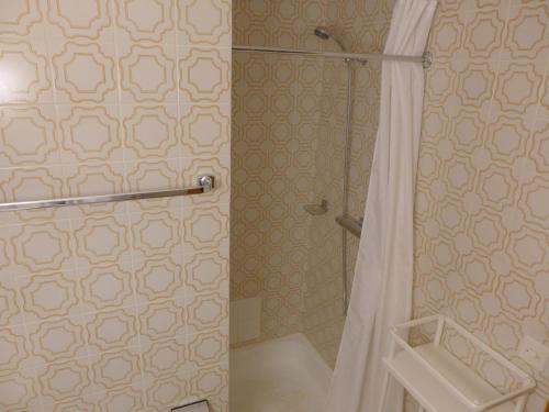a bathroom with a shower with a shower curtain at Apartment Résidence Maze B 10 by Interhome in Chermignon-dʼen Haut