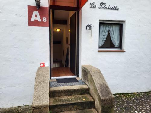 a stairway leading to a building with a window at Apartment Villaggio Sureggio A6 mit TicinoTicket by Interhome in Lugaggia