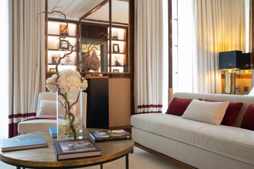 a living room with a couch and a table at Portrait Milano - Lungarno Collection in Milan