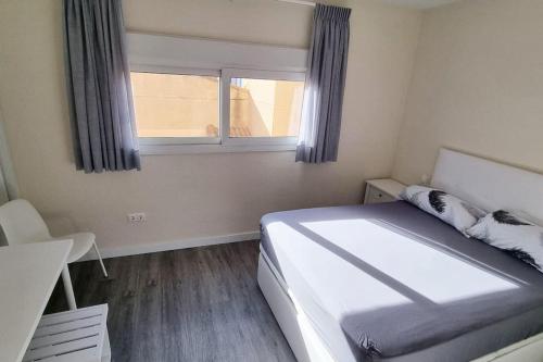 ein kleines Schlafzimmer mit einem Bett und einem Fenster in der Unterkunft Casa Ophélia - Albir in Albir