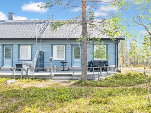 a blue house with a porch with a grill at Holiday Home Velho 2 by Interhome in Saariselka