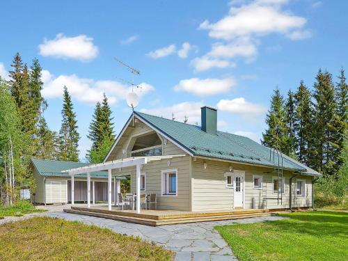 a large wooden house with a green roof at Holiday Home Riemurahi by Interhome in Pertunmaa