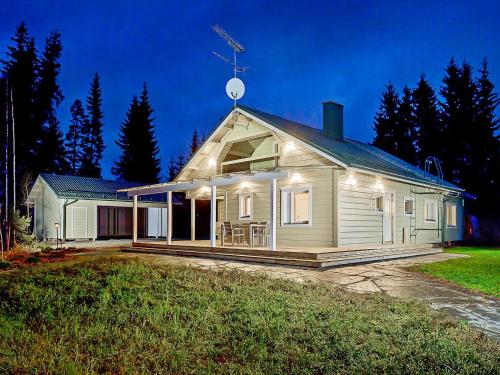 a white house with a satellite on top of it at Holiday Home Riemurahi by Interhome in Pertunmaa