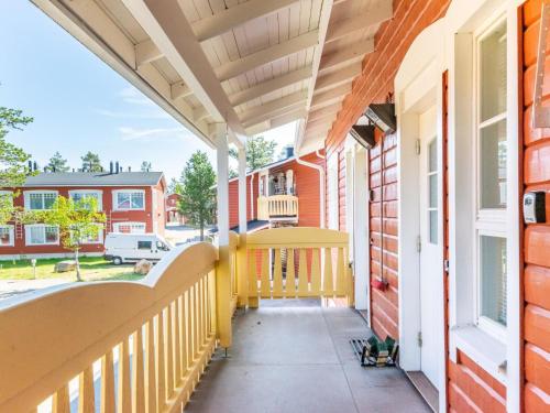 a porch of a home with a yellow railing at Holiday Home Outapailakka j 10 by Interhome in Saariselka