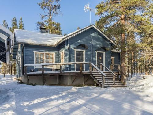 a blue house with a porch in the snow at Holiday Home Saaga by Interhome in Saariselka