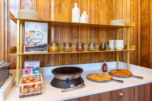 a kitchen counter with a stove with bread and dishes at Mercure Lyon Centre Château Perrache in Lyon