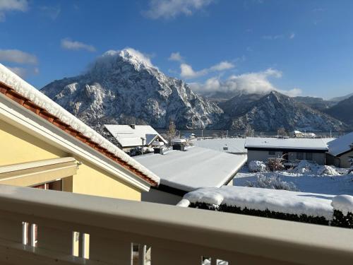 a view of a snow covered mountain from a house at Luxury-Suites Traunsee in Traunkirchen