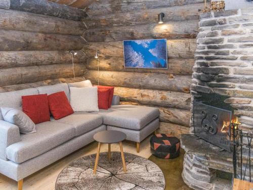 a living room with a couch and a fireplace at Holiday Home Talles by Interhome in Saariselka