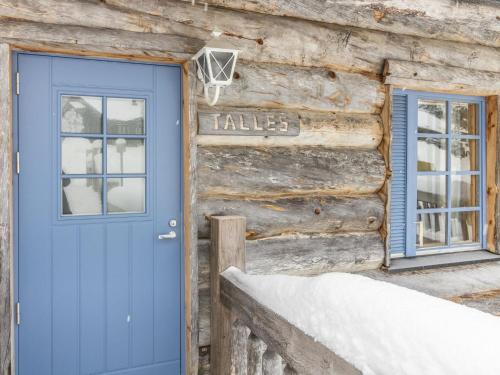 a blue door on the side of a log cabin at Holiday Home Talles by Interhome in Saariselka
