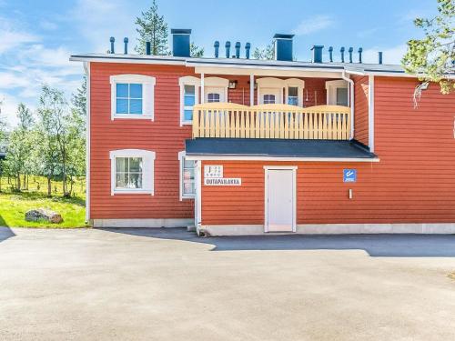 ein rotes Haus mit Balkon darüber in der Unterkunft Holiday Home Outapailakka j 9 by Interhome in Saariselkä