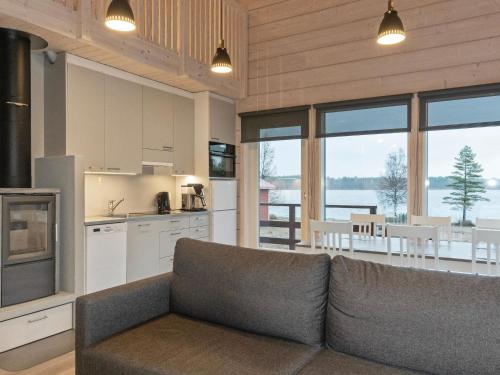 a living room with a couch and a kitchen at Holiday Home Siika by Interhome in Hailuoto