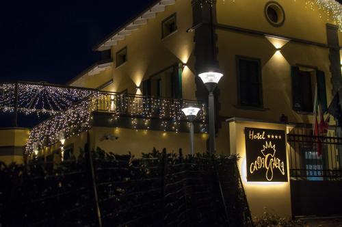 a building with christmas lights on the side of it at Hotel Ca' di Gali in Sasso Marconi