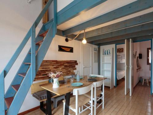une chambre avec une table et un escalier bleu dans l'établissement Holiday Home Les Charmilles-12 by Interhome, aux Mathes