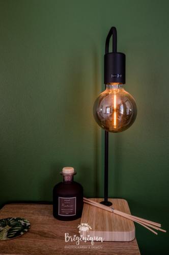 a lamp on a table next to a bottle of whiskey at SHB Sonvanger in St Helena Bay