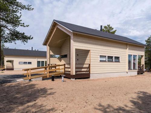 a large wooden building with a large roof at Holiday Home Taimen by Interhome in Hailuoto