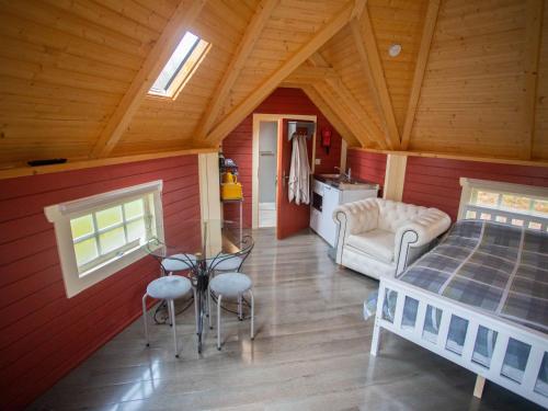 a bedroom with a bed and a table and chairs at Chalet Campbell by Interhome in Drumnadrochit