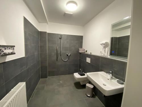 a bathroom with a sink and a toilet and a shower at New York Appartement in Bad Salzuflen