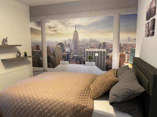 a bedroom with a large window with a city view at New York Appartement in Bad Salzuflen