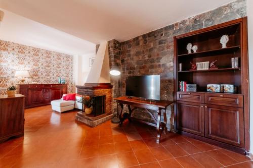 a living room with a table and a fireplace at A Casitta 2 Luxury Apartments in Taormina