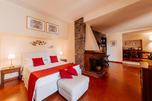 a bedroom with a large bed and a fireplace at A Casitta 2 Luxury Apartments in Taormina