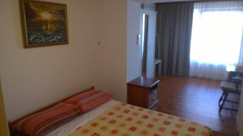 a bedroom with a bed and a painting on the wall at Apartment Sinčić in Novigrad Istria
