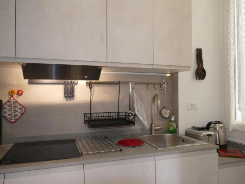 a kitchen with a sink and a counter top at Apartment Fiori e Canzoni by Interhome in Sanremo