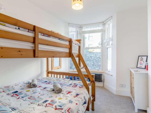 a bedroom with a bunk bed and a staircase at 3 Bed in Brixham 80655 in Brixham