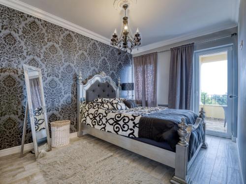 a bedroom with a bed and a chandelier at Holiday Home Villa Palazzo by Interhome in Lovran