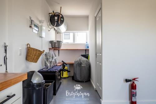 a kitchen with a floor with trash cans at SHB Sonvanger in St Helena Bay