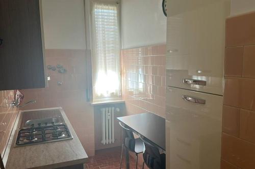 a small kitchen with a stove and a sink at Borgo Maria Luigia, prot. PG 0209465 in Parma