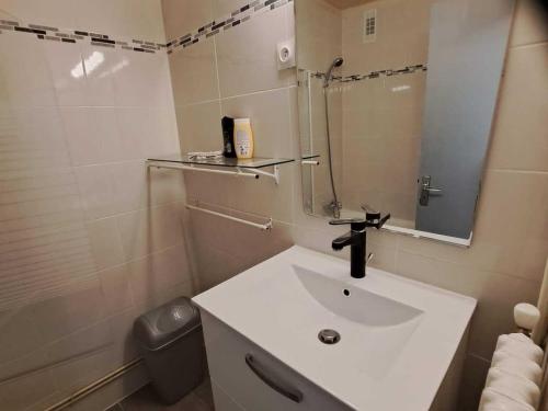 a white bathroom with a sink and a mirror at Studio Valloire, 1 pièce, 4 personnes - FR-1-263-55 in Valloire