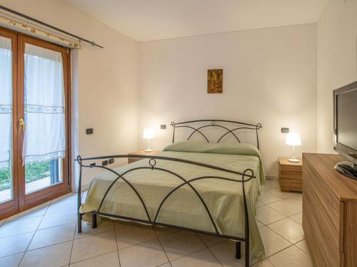 a bedroom with a bed and a tv and a window at Apartment Amendola by Interhome in Formia