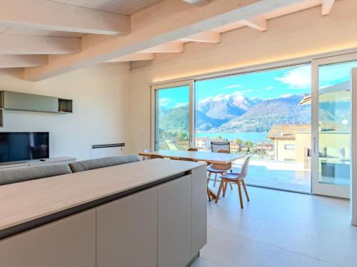 a kitchen and living room with a view of the mountains at Holiday Home Uliveto by Interhome in Colico