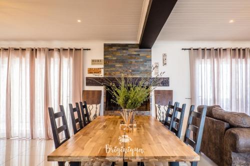 a dining room with a wooden table and chairs at SHB Sonvanger in St Helena Bay