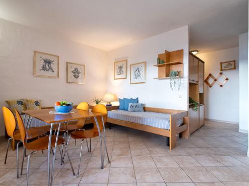 a living room with a bed and a table and chairs at Apartment B-0-3 - Marineledda by Interhome in Golfo Aranci