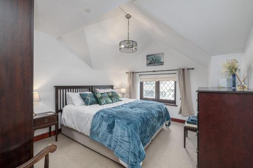 a bedroom with a large bed and a window at Preswylfa in Llanddeusant
