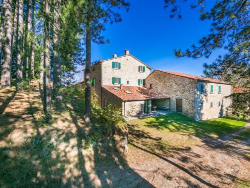 a large stone house in the middle of a forest at Holiday Home Al Volo del Nibbio by Interhome in Marradi